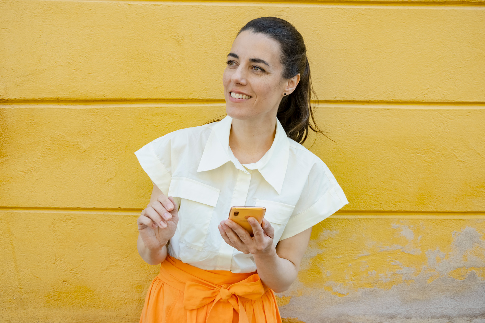 A woman holding a mobile phone.