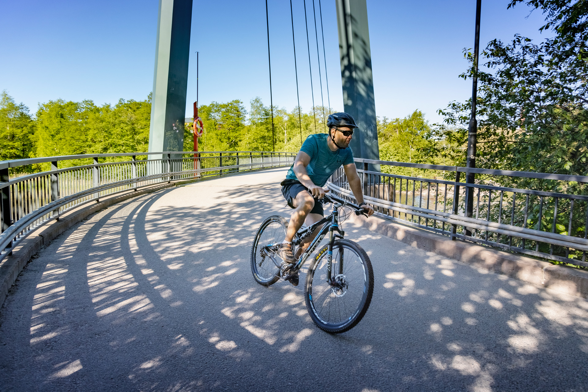 A man rides with a bike.